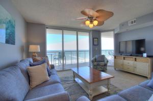 a living room with a couch and a tv and a table at Crescent Shores South - 510 in Myrtle Beach