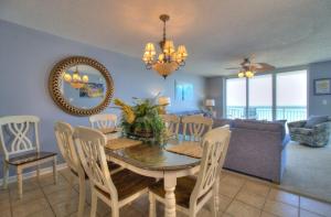 a dining room and living room with a table and chairs at Crescent Shores South - 510 in Myrtle Beach