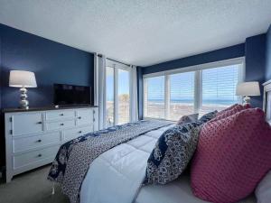 a bedroom with a large bed and a large window at Atlantic Dunes - 101 in Myrtle Beach +52 photos