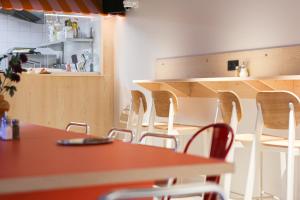 a room with a table and chairs and a counter at Mustard Hostel in Dijon +13 photos