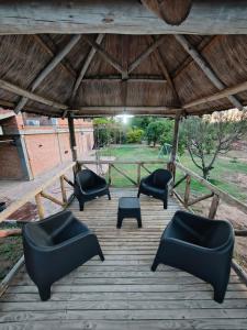 a group of chairs and tables on a patio at las palmeras departamento planta alta Catamarca in San Isidro