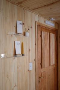 a room with a wooden wall with a door at Iar Residencia in El Chalten