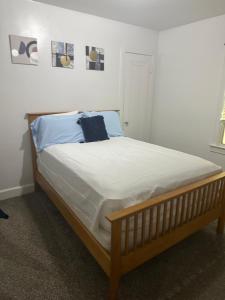 a bed in a bedroom with a wooden frame at Home Sweet Home in Detroit