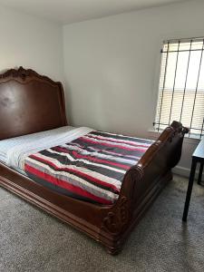 a bed with a wooden frame in a bedroom at Home Sweet Home in Detroit