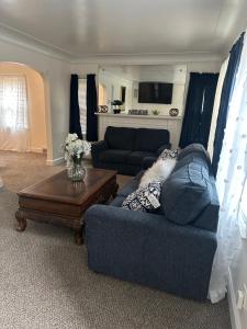 a living room with a blue couch and a table at Home Sweet Home in Detroit