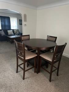 a dining room table with four chairs and a couch at Home Sweet Home in Detroit