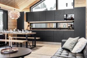 a living room with a table and a couch at LeviLakeVillas B in Levi