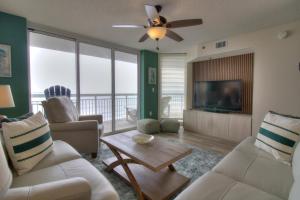 a living room with a couch and a tv at Crescent Shores South - 511 in Myrtle Beach