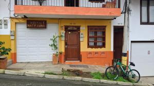 a bike parked in front of a house at Hostal Naty luna - sede alterna in Jardin