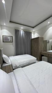 a bedroom with two beds and a sink at شقق واڤا in Tabuk