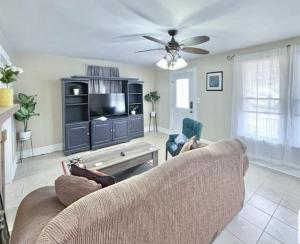 a living room with a couch and a tv at The Honey Home in Martinsville