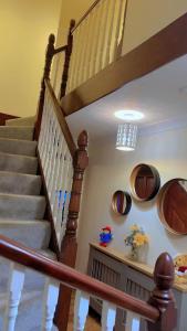 a staircase in a home with wooden railings at Bnb in Abbeymead
