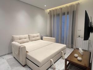 a bedroom with a large bed and a table at Breeze La Marsa in Tunis