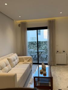 a living room with a couch and a table at Breeze La Marsa in Tunis +18 photos