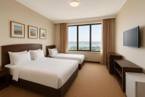 a hotel room with two beds and a window at Rest Deluxe Hotel in Baku +45 photos