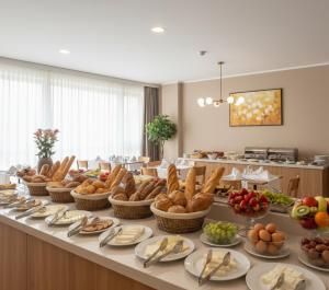 a buffet line with baskets of bread and other foods at Trabzon Live Hotel in Bostancı
