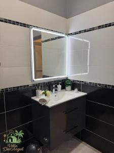 a bathroom with a sink and a mirror at Villa DAV'ANGEL in Le Lamentin +18 photos