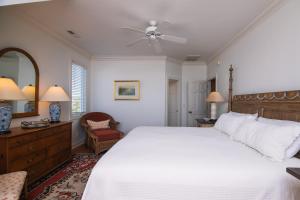 a bedroom with a large bed and a ceiling fan at Alvarez II in Edisto Island
