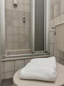 a bathroom with a white toilet and a shower at Parkhotel Essen in Essen +134 photos