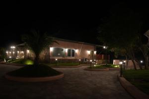 a building at night with lights in front of it at Wild Forest By Nirvana in Sasan Gir