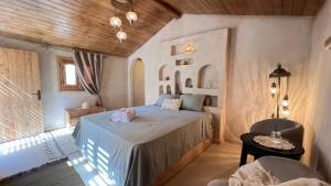 a bedroom with a bed and a table and a chair at Meddur Siwa Oasis in Siwa