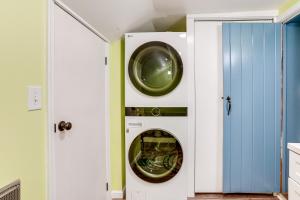 a washer and dryer in a room with a door at Blue Ridge Retreat! Cottage on the Rapidan River in Locust Dale