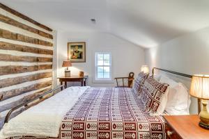 a bedroom with a bed and a wooden wall at Blue Ridge Retreat! Cottage on the Rapidan River in Locust Dale