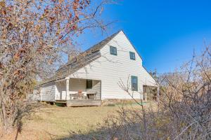 a white house with a gambrel roof at Blue Ridge Retreat! Cottage on the Rapidan River in Locust Dale