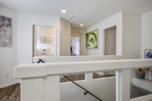 a white bathroom with a sink and a mirror at Relaxing Vegas Stay with BBQ & Games in Las Vegas +67 photos