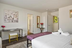 a bedroom with a large white bed and a desk at Relaxing Vegas Stay with BBQ & Games in Las Vegas