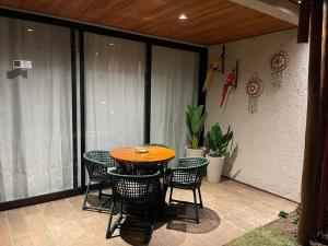 a patio with a table and chairs on a balcony at Naay Villas - Flat Beira Mar - Sao Miguel dos Milagres in Pôrto de Pedras