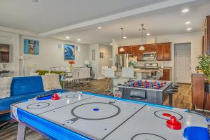 a living room with a table with a game at Relaxing Vegas Stay with BBQ & Games in Las Vegas