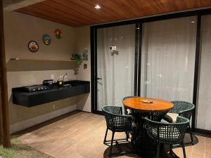a patio with a table and chairs and a sink at Naay Villas - Flat Beira Mar - Sao Miguel dos Milagres in Pôrto de Pedras