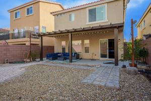 a house with a patio in front of it at Relaxing Vegas Stay with BBQ & Games in Las Vegas