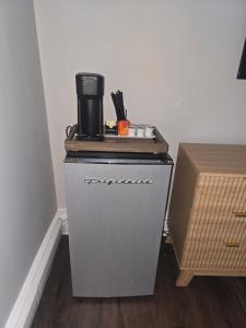 a small cabinet with a coffee pot on top of it at Cozy Room in Revere near Beachmont Blue Line Station in Boston
