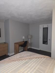 a bedroom with a bed and a desk and a desk at Cozy Room in Revere near Beachmont Blue Line Station in Boston