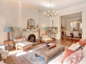 a living room with a fireplace and a table at Elsewhere on Madison Square Main in Savannah +40 photos
