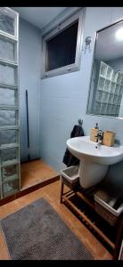 a bathroom with a sink and a mirror at Casa Piszi in Torrevieja +26 photos