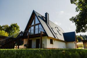 a house with a gambrel roof with a deck at Ferienhaus Lärchenblick in Kurort Altenberg