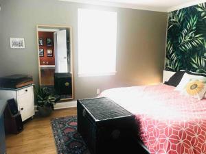 a bedroom with a large bed and a large window at Downtown - 2 bed, 1 bath - KC in Raleigh