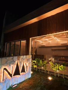 a facade of a house at night with lights at Naay Villas - Flat Beira mar exclusivo in Pôrto de Pedras