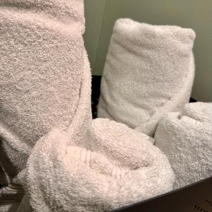 a pile of white towels sitting on top of a bed at 110 - Green Forest in Lewarde +18 photos