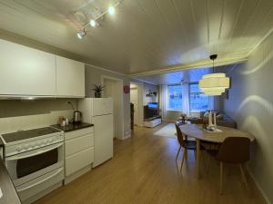 a kitchen and dining room with a table and a dining room at Modern 2 bedroom apartment in the heart of Tromsø in Tromsø