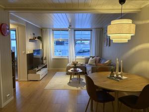 a living room with a table and a couch at Modern 2 bedroom apartment in the heart of Tromsø in Tromsø