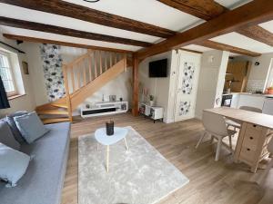 a living room with a couch and a table at Cottage A day in Strasbourg in Strasbourg