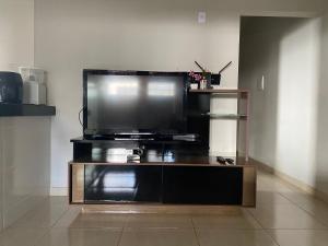 a flat screen tv sitting on top of a entertainment center at Casa Bela Vista in São Roque de Minas