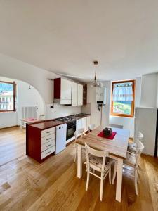 a kitchen and dining room with a table and chairs at Appartamento Conca Epolo in Schilpario +13 photos
