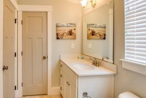 a bathroom with a sink and a mirror at 410A The Jetty House in Virginia Beach +30 photos