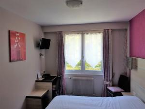 a hotel room with a bed and a window at Auberge Le Moulin Du Plain in Goumois