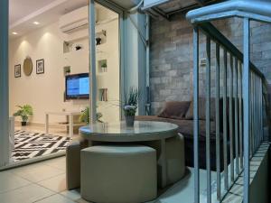 a living room with a glass table and a couch at Modern apartment with garden in Sheikh Zayed